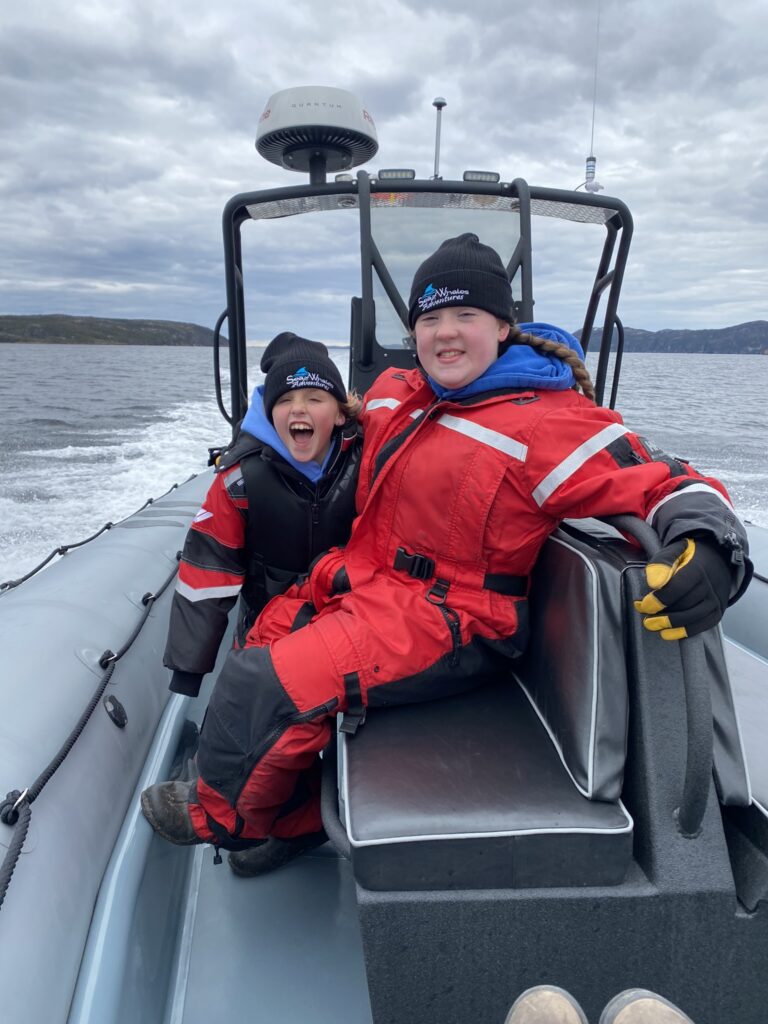 having fun and keeping warm and dry on a whale watching excursion in Trinity Bay